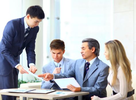 Business team interviewing young applicant in bright office