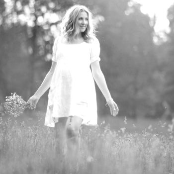 happy pregnant woman walking in the Park on a Sunny day. Black and white photo
