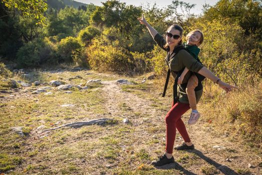 Woman with babywearing baby on a long hike outdoor.