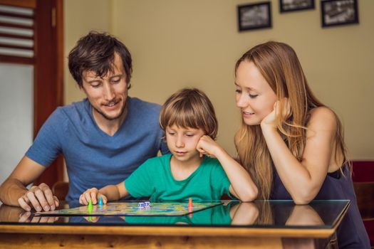 Happy Family Playing Board Game At Home.