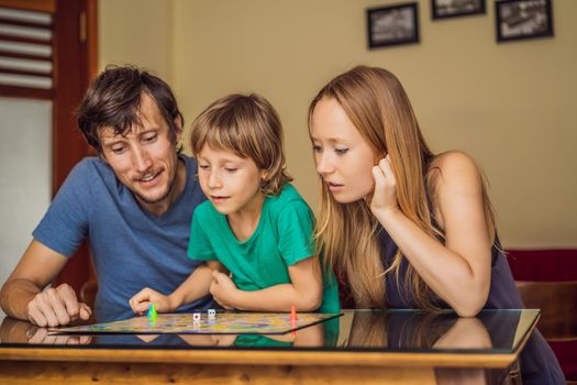 Happy Family Playing Board Game At Home.