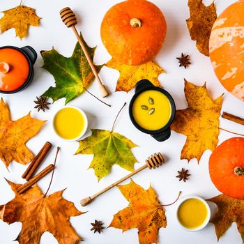 Autumn food. Pumpkin puree soup, leaves. Top view. Autumn harvest, pumpkins, leaves on grey as abstract background. View from above. Thanksgiving day. Flat lay.