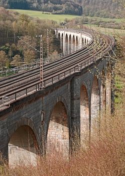 View on an old railway viaduct. It is a 482 metres long and up to 35 metres high and made out of limestone in 1853.  It spans a valley west of the town of Altenbeken, NRW, Germany. The king, who inaugurated it, joked “I had thought I would find a golden bridge, because so much money has been spent”