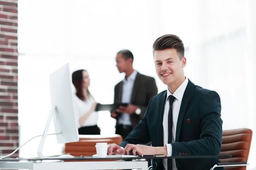 employee sitting behind a Desk in the office .photo with copy space
