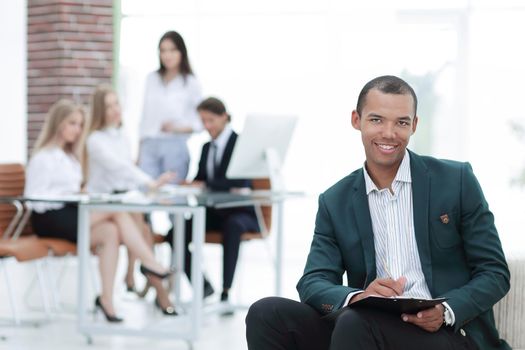 young businessman signing a document in his office.photo with copy space