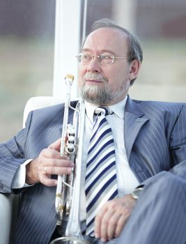 close up.adult male musician sitting in a chair.