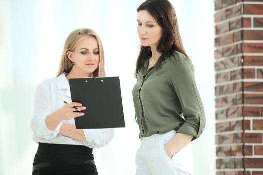 closeup.business woman and an assistant discussing working papers.