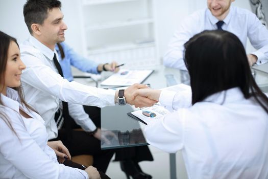handshake of financial partners at a business meeting in the office.