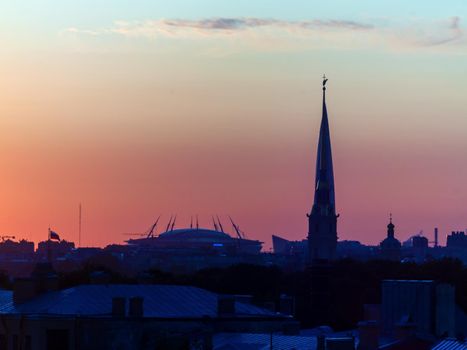ST. PETERSBURG. RUSSIA - August 28, 2019. Krestovsky stadium, the Lakhta Center skyscraper and the Peter and Paul Fortress against a bright sunset sky.