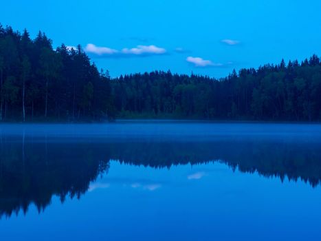 Sunrise and fog in a beautiful lake in Karelia.