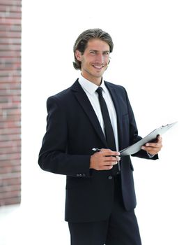 handsome businessman with business document standing in office
