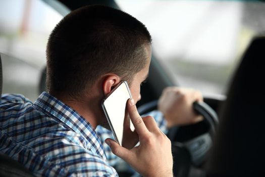 rear view.modern man talking on a smartphone, sitting in the car.close up.