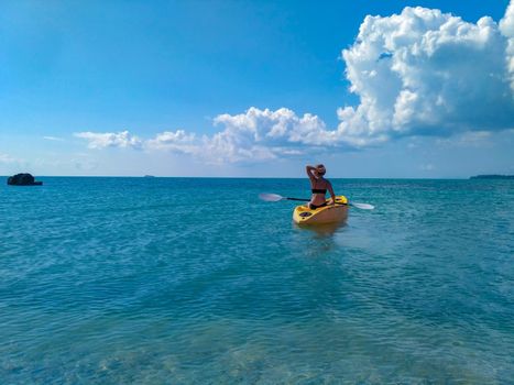 Brunette girl kayaking through lover's key kayak trail.