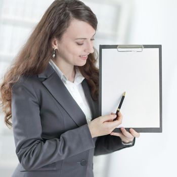 modern business woman pointing at blank sheet. .photo with copy space