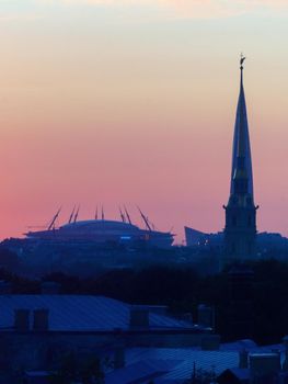 ST. PETERSBURG. RUSSIA - August 28, 2019. Krestovsky stadium, the Lakhta Center skyscraper and the Peter and Paul Fortress against a bright sunset sky.