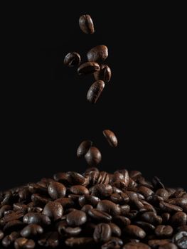 falling coffee beans on the dark background.