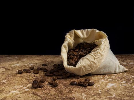 coffee beans in a bag on a wooden background.