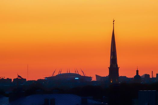 ST. PETERSBURG. RUSSIA - August 28, 2019. Krestovsky stadium, the Lakhta Center skyscraper and the Peter and Paul Fortress against a bright sunset sky.