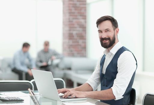 businessman sitting at his Desk in the office .people and technology