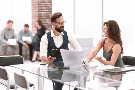business colleagues discuss business issues sitting at the Desk.business concept