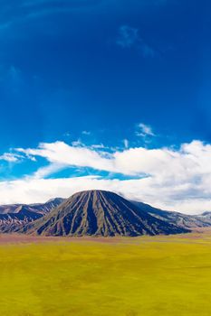 Volcanic landscape against blue sky with clouds. Bromo Tengger Semeru National Park, East Java, Indonesia