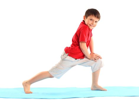 Children's yoga. The little boy does exercise.