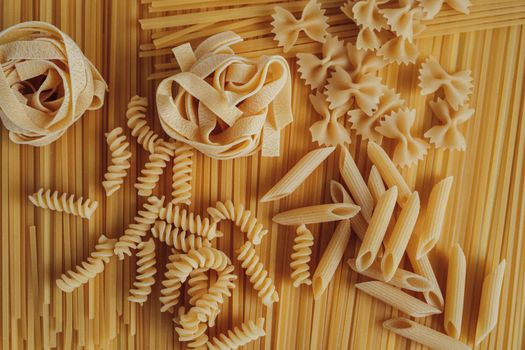 Different Types of Pasta Laid Out on Background of Spaghetti