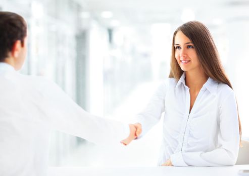 Cheerful businesspeople, or businesswoman and client handshaking