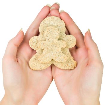 Woman hands holding two gingerbread men cookie isolated on white background. Christmas biscuits