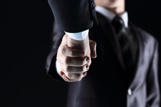 Handshake - Hand holding on dark background