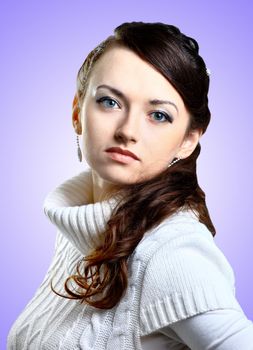 Beautiful girl in sweater. Isolated on a purple background.