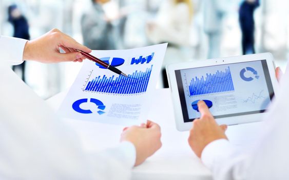 Close-up of businessman explaining a financial plan to colleagues at meeting