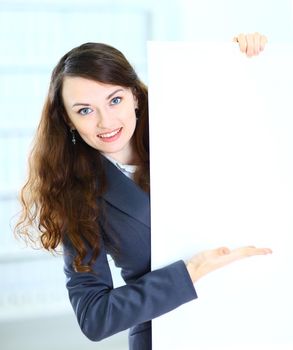 Happy smiling young business woman showing blank signboard, isolated on white background