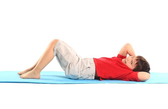 Children's yoga. The little boy does exercise.