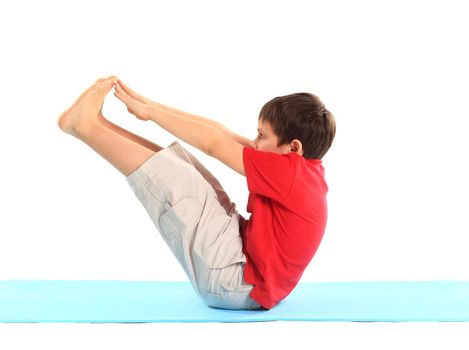 Children's yoga. The little boy does exercise.