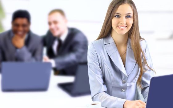 Beautiful businesswoman keeps the laptop. Isolated on a white background.