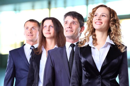 Group of friendly businesspeople with happy female leader in front