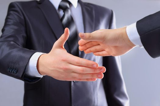 Photo of handshake of business partners after signing promising contract