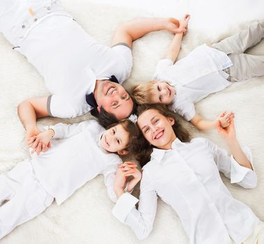 Kind, happy family relaxing at home.