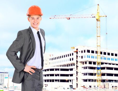 Engineer With Red Hard Hat and Blueprint Under the Power Lines.Engineer holding blueprints at an electrical substation.