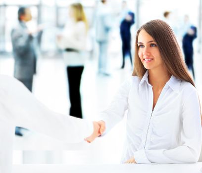 Cheerful businesspeople, or businesswoman and client handshaking