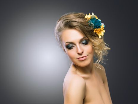 Young beautiful attractive girl with flowers in her hair. Posing for the camera.