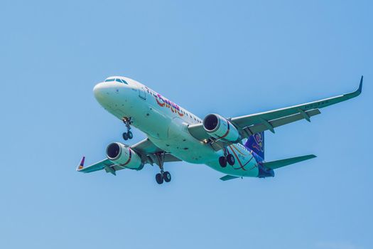 Vietnam, NhaTrang, 04.05.2020: Coronavirus is over. Quarantine weakened. Take off the mask. Now you can travel. Modern airplane Thai SMILE in the sky near Airport. takes off or landing.