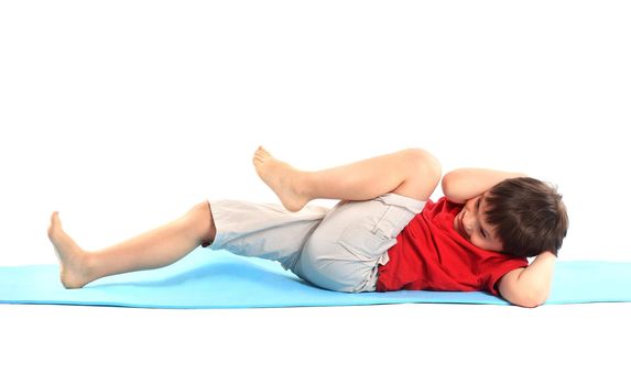 Children's yoga. The little boy does exercise.