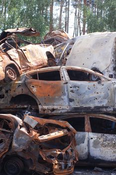 war in ukraine. Car graveyard. Shot cars of civilians. russia's war against Ukraine. Burnt and blown up car. Cars damaged after shelling. irpin bucha. war crimes.