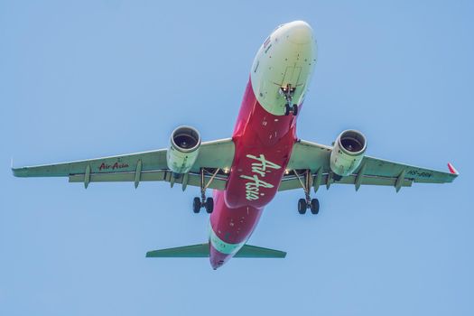 Vietnam, NhaTrang, 04.05.2020: Coronavirus is over. Quarantine weakened. Take off the mask. Now you can travel. Modern airplane Airasia in the sky near Airport. takes off or landing.