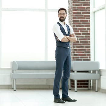 confident businessman standing in the office lobby. photo with copy space