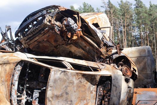 war in ukraine. Car graveyard. Shot cars of civilians. russia's war against Ukraine. Burnt and blown up car. Cars damaged after shelling. irpin bucha. war crimes.