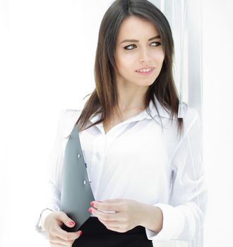 portrait of a serious young business woman on the background of the office.