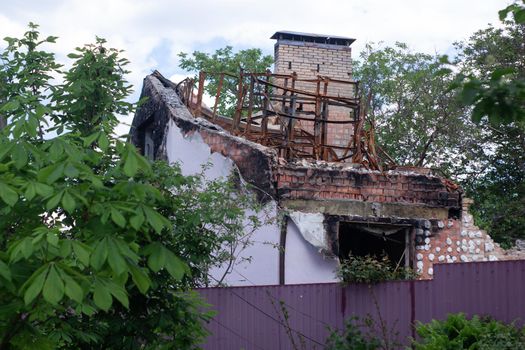 consequences of russian war crimes. destroyed houses in irpin city, ukraine. mortar shell hit someone home during war.